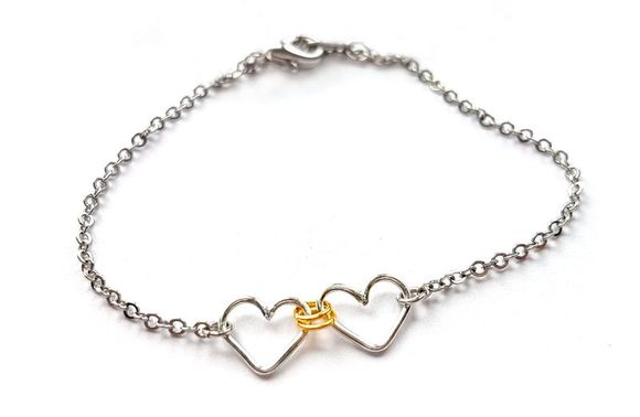 Two small linked hearts bracelet by Fiore Jewellery