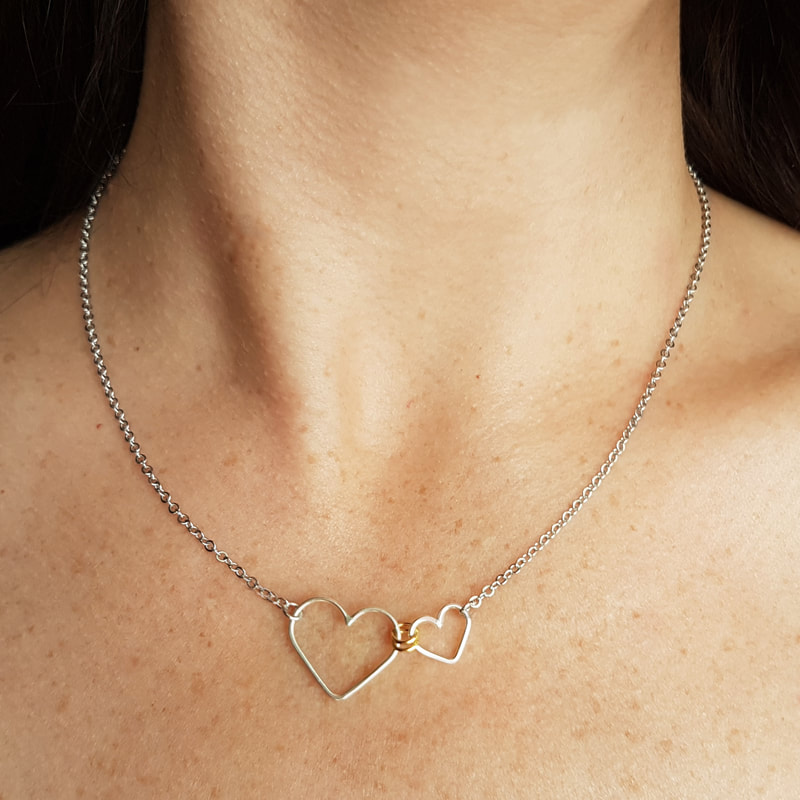 Large and small linked heart necklace by Fiore Jewellery