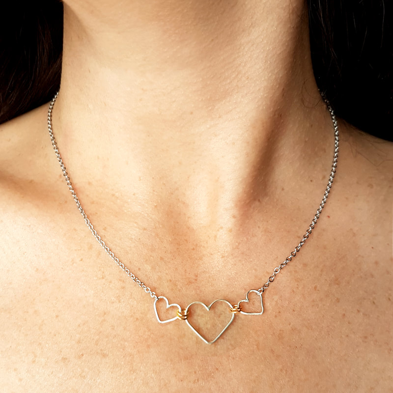 One large and two small linked heart necklace by Fiore Jewellery